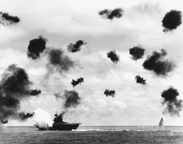 USS Yorktown is hit by a Japanese aerial torpedo during the Battle of Midway